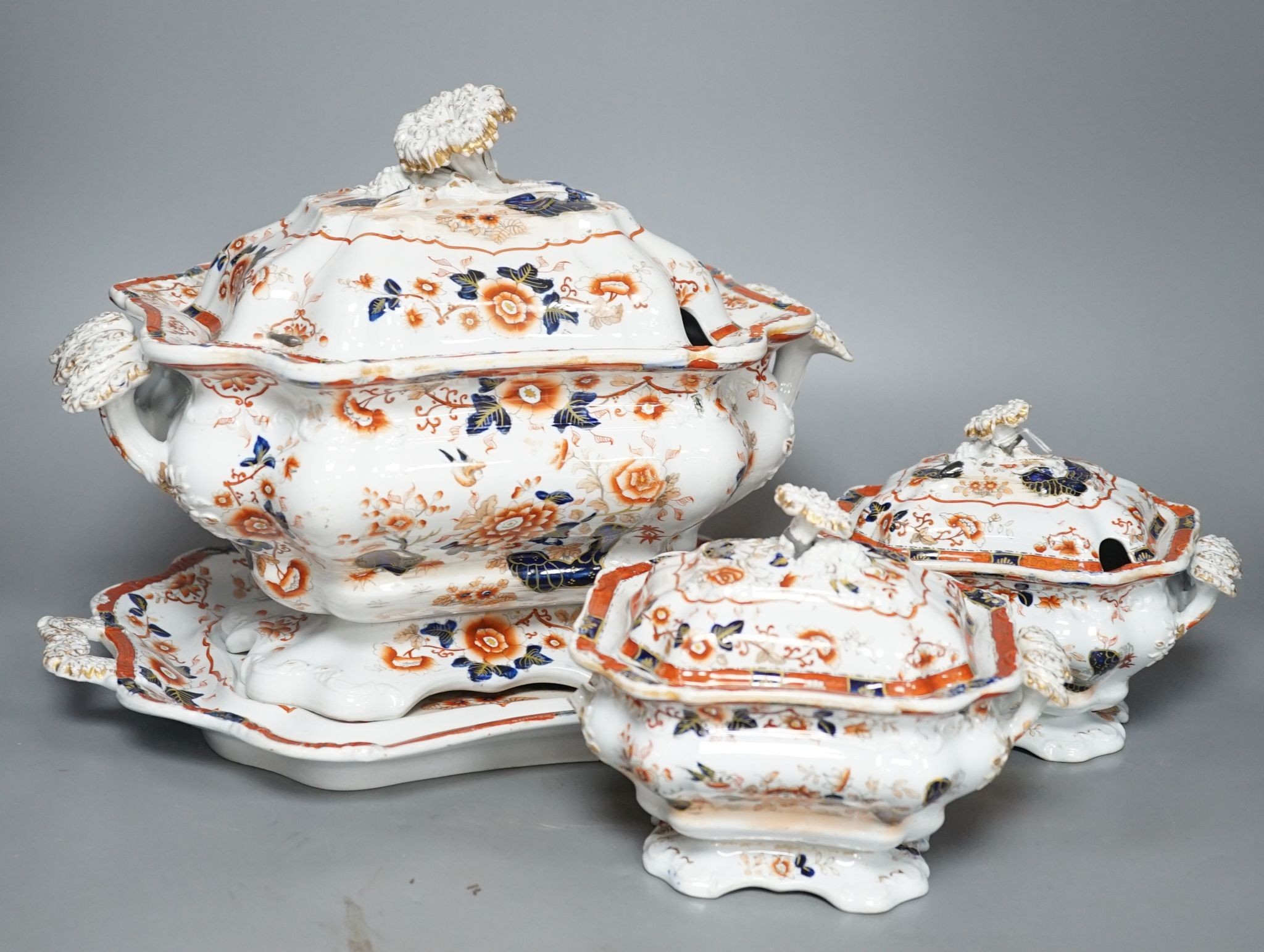 An early 19th century stoneware soup tureen and cover on stand, decorated in cobalt blue and iron red, a similar tureen, a pair of small covered dishes, Staffordshire spaniels, etc.